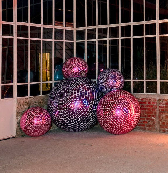 Decorative interior with pink spherical objects and a chandelier.