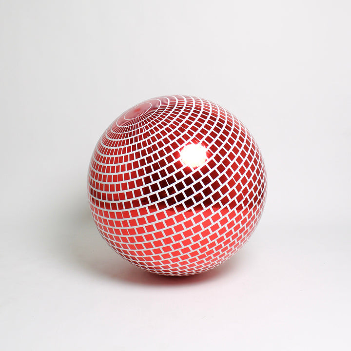 Red and white spherical object with a grid pattern on a light gray background