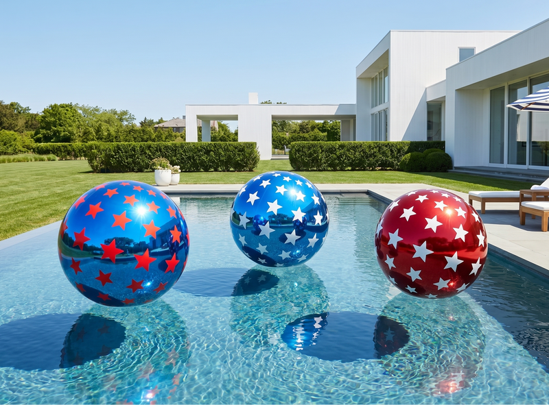 Three inflatable pool balls with star patterns in a pool area with a house and lawn in the background.