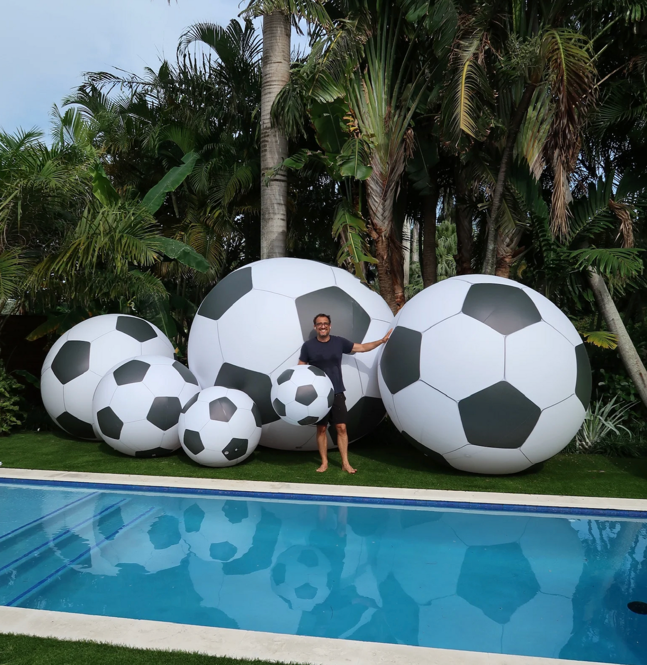 Giant inflatable soccer balls multiple sizes backyard pool World Cup 2026 display