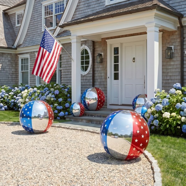 Decorative spheres with American flag design in front of a house with an American flag.