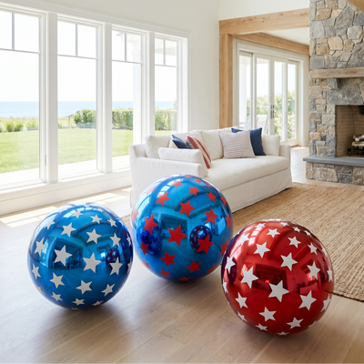 Three inflatable exercise balls with star patterns on a wooden floor in a bright living room.